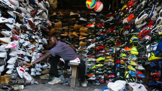 a-kenyan-self-employed-business-man-agustine-karani-arranges-shoes-at-his-shop-in-nairobi